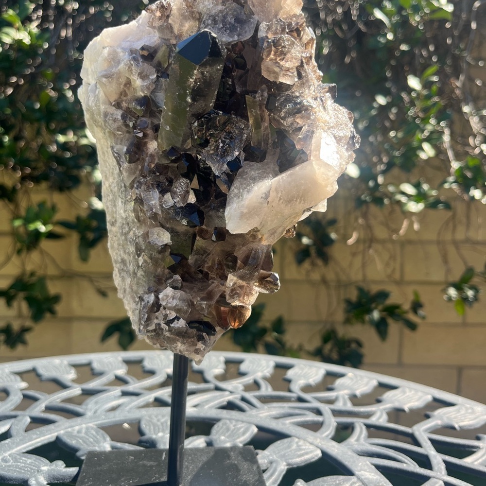 Smokey quartz crystal sculpture on stand